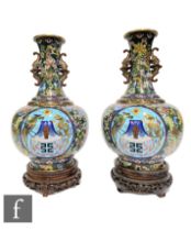 A pair of Chinese cloisonne vases, each of bottle form, rising to a slender neck applied with cicada