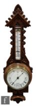 A Victorian carved oak aneroid barometer incorporating thermometer, the dial Great Gales to Very Dry