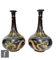 A pair of late Qing Dynasty Chinese cloisonne vases of bottle form, enamelled with two dragons in