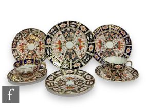 A 20th Century Royal Crown Derby porcelain teacup, saucer and plate decorated in the 2451 Imari