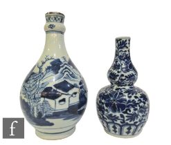 Two Chinese blue and white vases, to include an 18th Century example of bottle form, height 23cm,