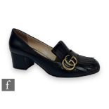 A pair of Gucci black leather mid heel loafers, with black fringe details and overlapping GG in gold