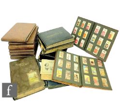 An extensive collection of cigarette cards contained in thirteen albums, Players, Wills and