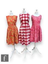 Three 1950s/60s lady's vintage sleeves A line dresses, the first in an abstract floral pattern in