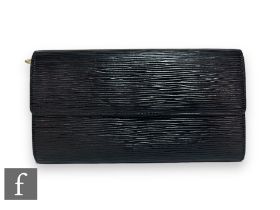 A 1990s Louis Vuitton black Epi leather Porter Tresor long wallet, with fold-over front flap,