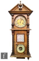 A late Victorian walnut cased wall clock/barometer, circular dial with eight day movement above a