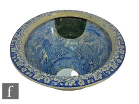 A 19th Century Staffordshire blue and white toilet bowl printed with figures in a rowing boat,