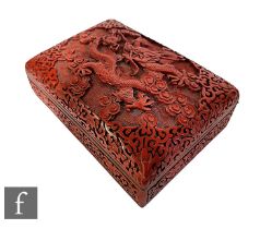 A Chinese Cinnabar lacquer box, the rectangular box with hinged cover, deeply carved with five-