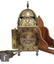 A 17th Century style brass lantern clock with chain driven movement with single weight below a