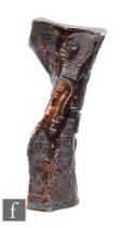 A large section of cow bone carved with African faces and figures some seated, height 48cm.