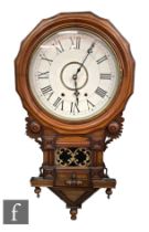 A Victorian walnut wall clock, the circular white dial within a shaped inlaid border enclosed by a