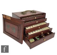 A Chinese Mah Jong set, the five drawer set enclosing stained pieces, the rosewood box with