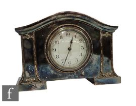 An Edwardian plated mantle clock, circular white Arabic numeral dial in shaped case, width 24cm.