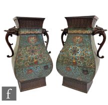 A pair of late Qing Dynasty Chinese Archaic style enamelled vases, each of baluster form, flanked by