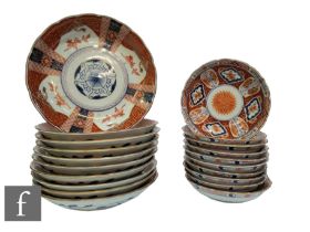 A collection of Japanese Imari dishes, to include ten smaller dishes and ten larger dishes, all