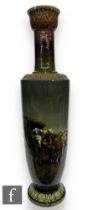 A large late 19th Century Bretby cylindrical 'Long Tom' vase, impasto decorated with a scene of