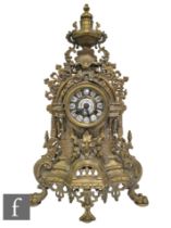 A late 20th Century Louis XIV style gilt mantle clock, surmounted with an urn over a dial, on mask