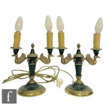 A pair of post 1950s French Empire style double sconce gilt table lamps, the branches modelled as
