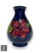 A post war Moorcroft Pottery vase by Walter Moorcroft, of footed ovoid form with waisted collar