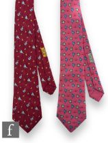 A 1980s Hermes silk tie, pattern number 7566 SA depicting blue cockerels and clocks over a pink