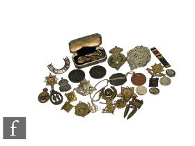 A collection of military cap badges to include Royal Engineers, Argyll and Sutherland,