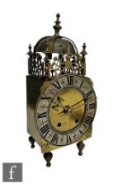 A late 19th to early 20th Century brass lantern clock, the bell canopy above a pierced gallery and a