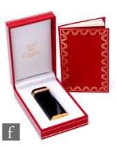 A Must De Cartier black lacquer Briquet lighter, height 7cm, complete with inner and outer boxes