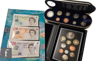 An Elizabeth II Royal Mint 2012 proof set, a five pound 'Time Capsule' set and three framed