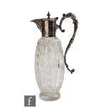 An early 20th Century silver plated and clear cut glass claret jug with ovoid clear cut glass body