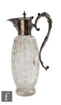 An early 20th Century silver plated and clear cut glass claret jug with ovoid clear cut glass body