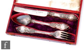 A cased Russian silver knife, fork and spoon set each with shell and foliate scroll decoration, St