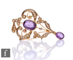 An Edwardian 9ct amethyst and seed pearl pendant/brooch with collar set amethyst central stone and