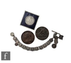 A Victoria 1892 crown, a 1887 bronze medallion, a threepence coin bracelet, damaged, and a Lusitania