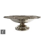 A hallmarked silver comport, circular foot below plain bowl with pierced scroll detail to borders,