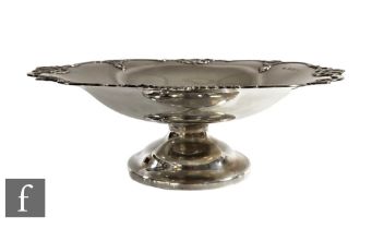 A hallmarked silver comport, circular foot below plain bowl with pierced scroll detail to borders,