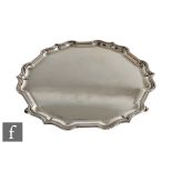 A hallmarked silver circular salver of plain form with pie crust border, weight 18oz, diameter 26cm,