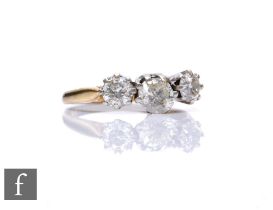 An 18ct hallmarked diamond three stone ring, claw set brilliant cut stones, total weight