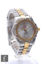 A lady's gold and stainless steel Tag Heuer quartz wrist watch ref WK 1320with batons and date
