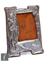 An early 20th Century silver mounted oak easel-back 'Valkyrie' photograph frame, embossed figure