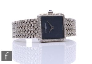 An 18ct white gold lady's Baume & Mercier manual wind wrist watch, silvered hand to a square black