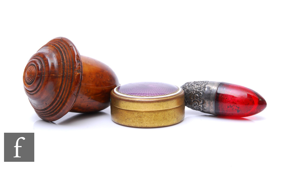 A hallmarked silver and cranberry glass miniature scent bottle, length 4.5cm, with a carved wooden