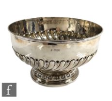 A hallmarked silver punch bowl with part fluted decoration to circular foot and body, weight 32oz,