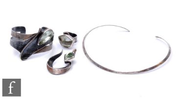 A modern suite of jewellery comprising collarette, a bangle, a ring and a pendant, three set with