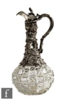 A late 19th Century silver plated and clear cut glass claret jug with hob nail cut globe and shaft