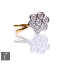 An 18ct diamond daisy cluster pendant, seven brilliant cut collar set stones, total weight