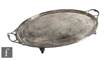An early 20th Century silver plated oval twin handled tray of plain form terminating in reeded
