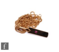 A 9ct pendant modelled as a cricket bat set with central single ruby, length 3.5cm, suspended from a