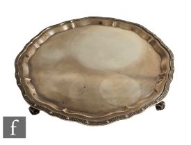 A hallmarked silver salver of plain form with Celtic style decoration, weight 44oz, diameter 36cm,