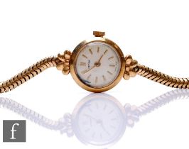 A lady's 9ct hallmarked Netex wrist watch, gilt batons to a circular dial to a snake link