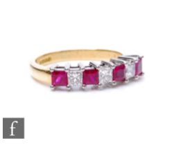 An 18ct hallmarked ruby and diamond half eternity ring comprising seven alternating square cut